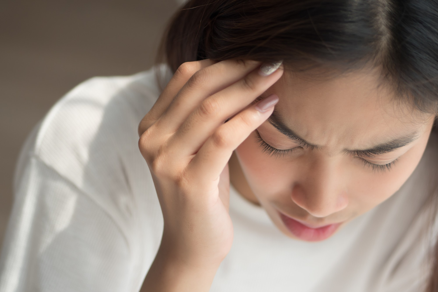 Portrait of stressed and sick woman with headache
